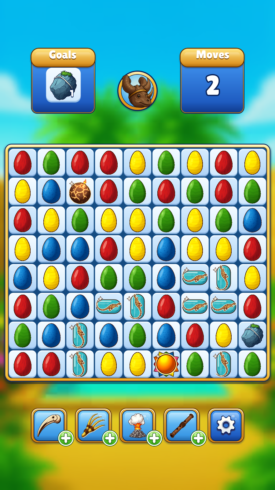 A level in play: a board of dinosaur eggs with a goal, a move counter and boosters underneath