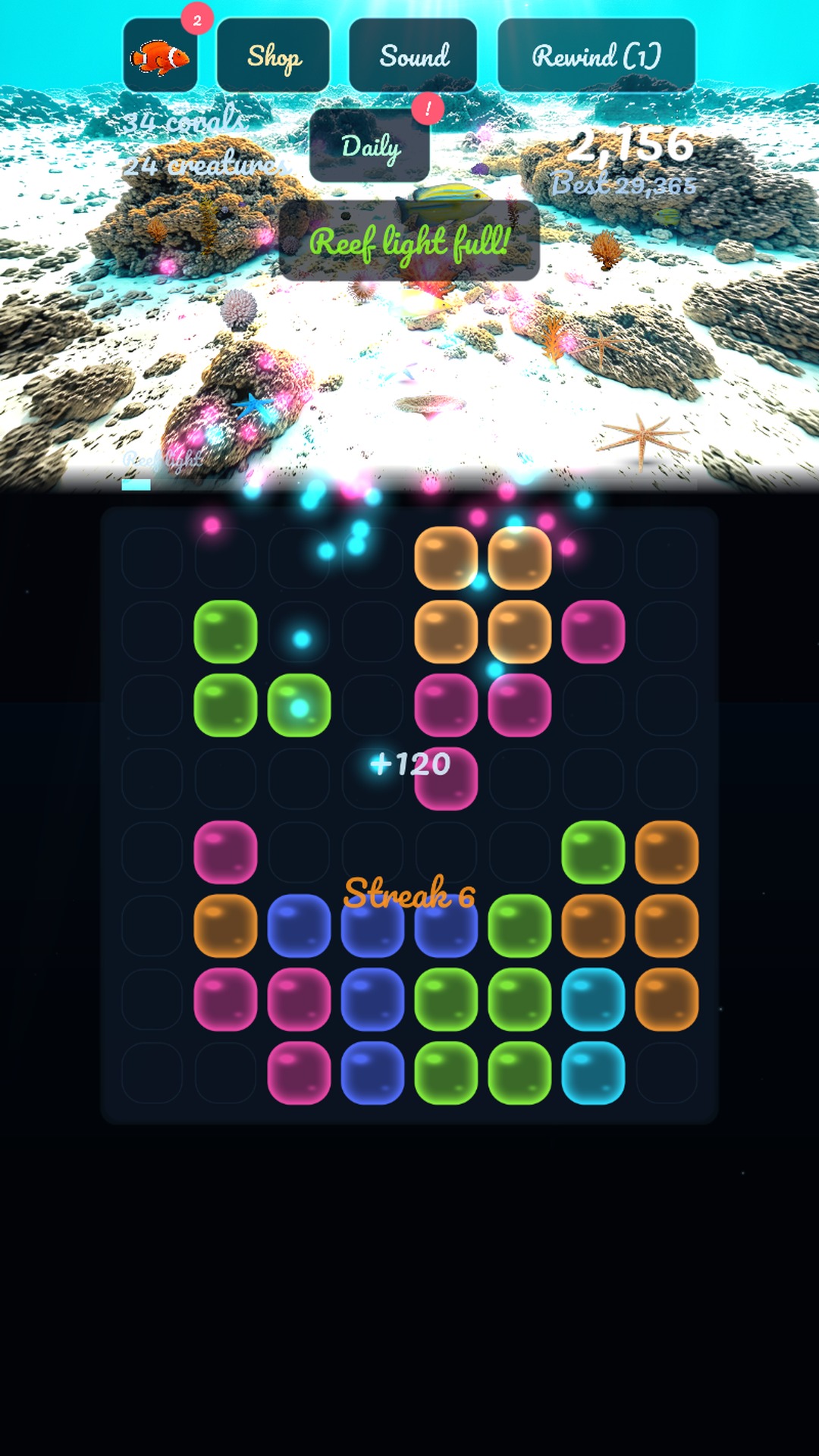 The reef lit up behind the 8 by 8 board, with three pieces waiting to be placed